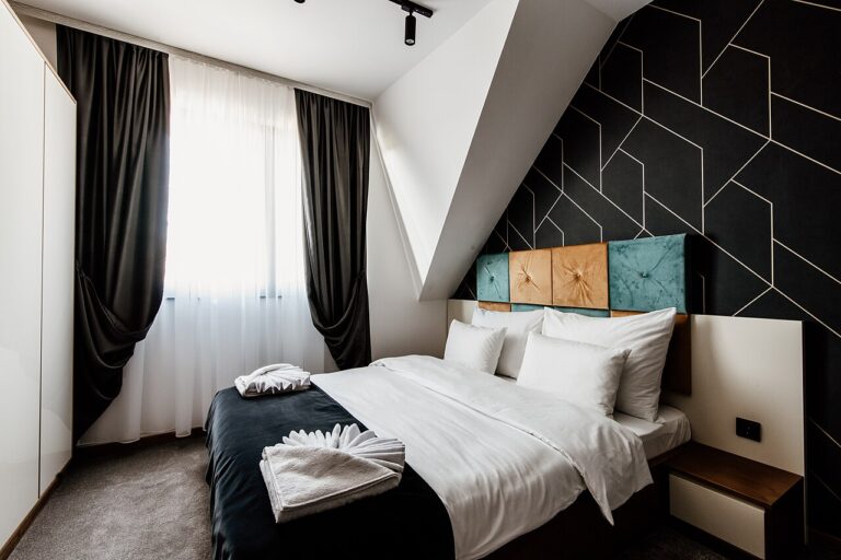 A bright, modern bedroom with soft linens and natural light